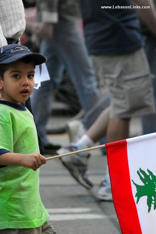 Little Boy walking with a Flag