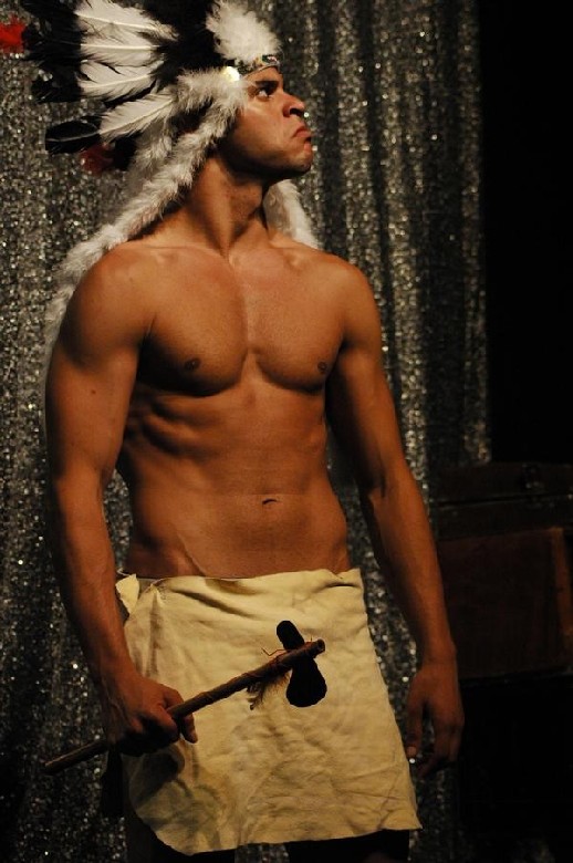 Photo of Djamel Mehnane on stage as a native Indian American character from a theatrical play