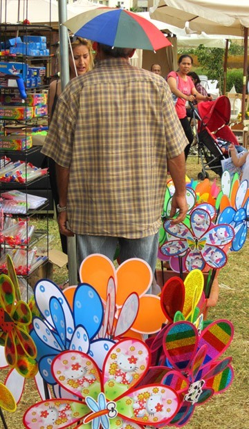 Man selling colorful gadgets at garden show 